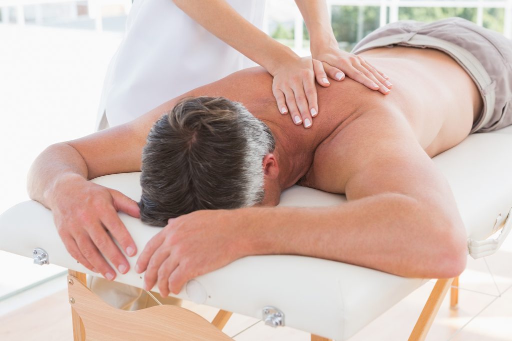 Massage therapist providing treatment to a patient