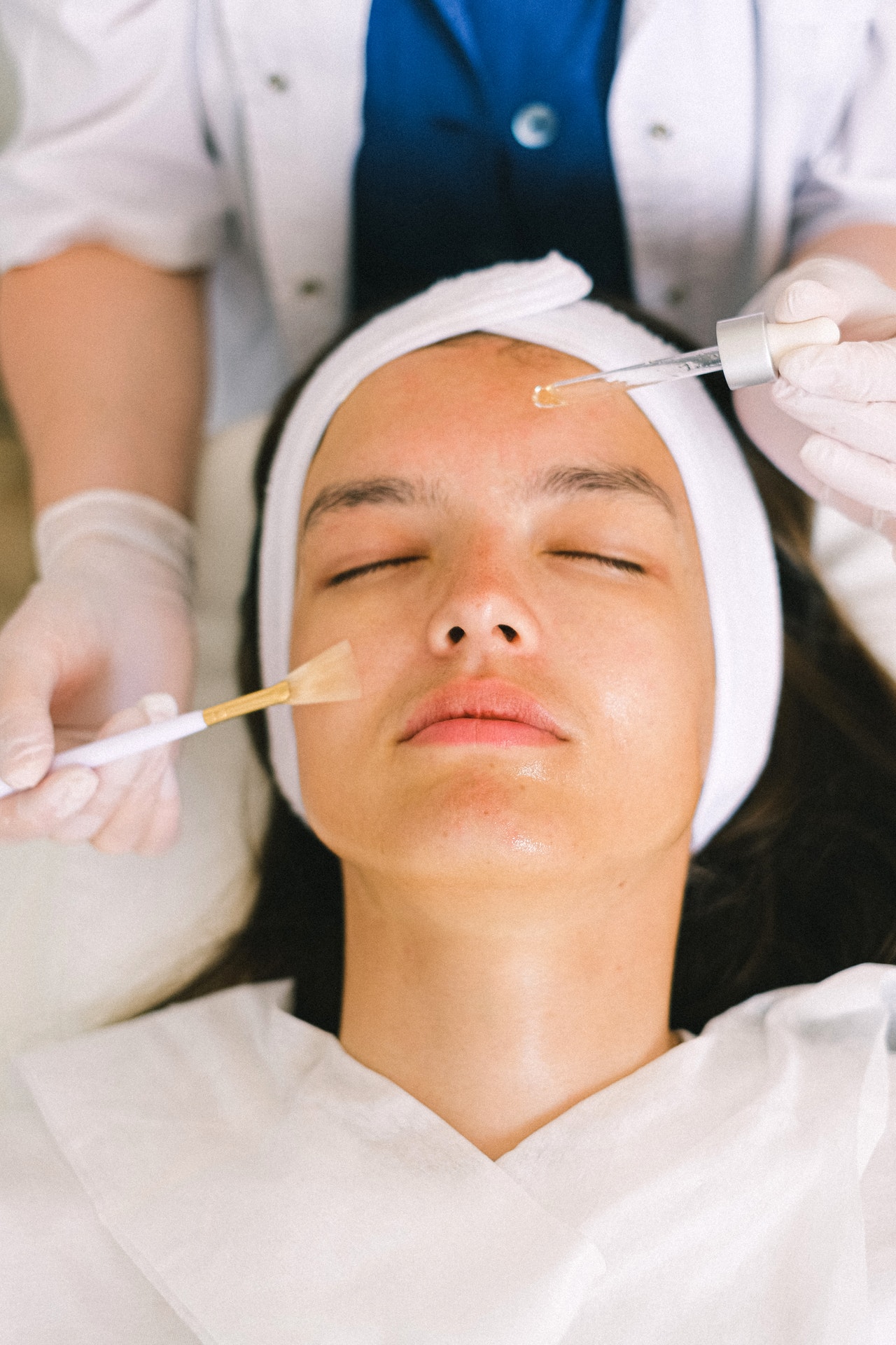 beautician applying product on a face