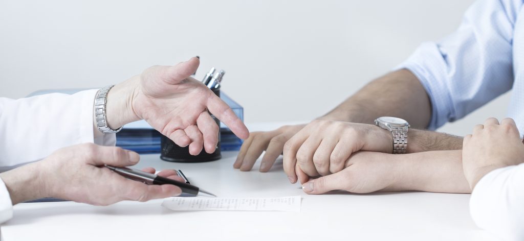Married couple holding hands during a sexologist consultation
