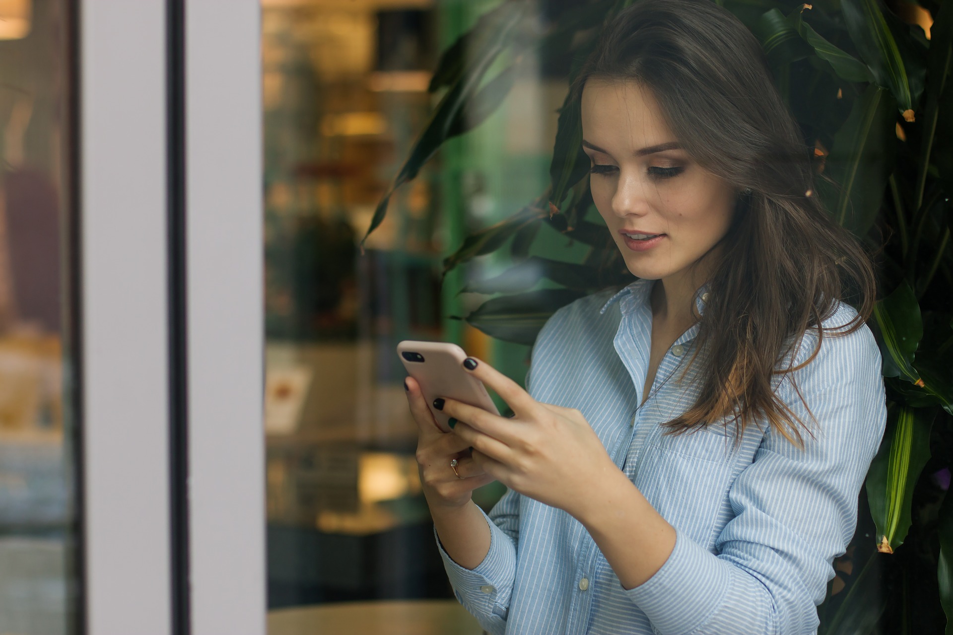 Woman using a smartphone representing user behavior.