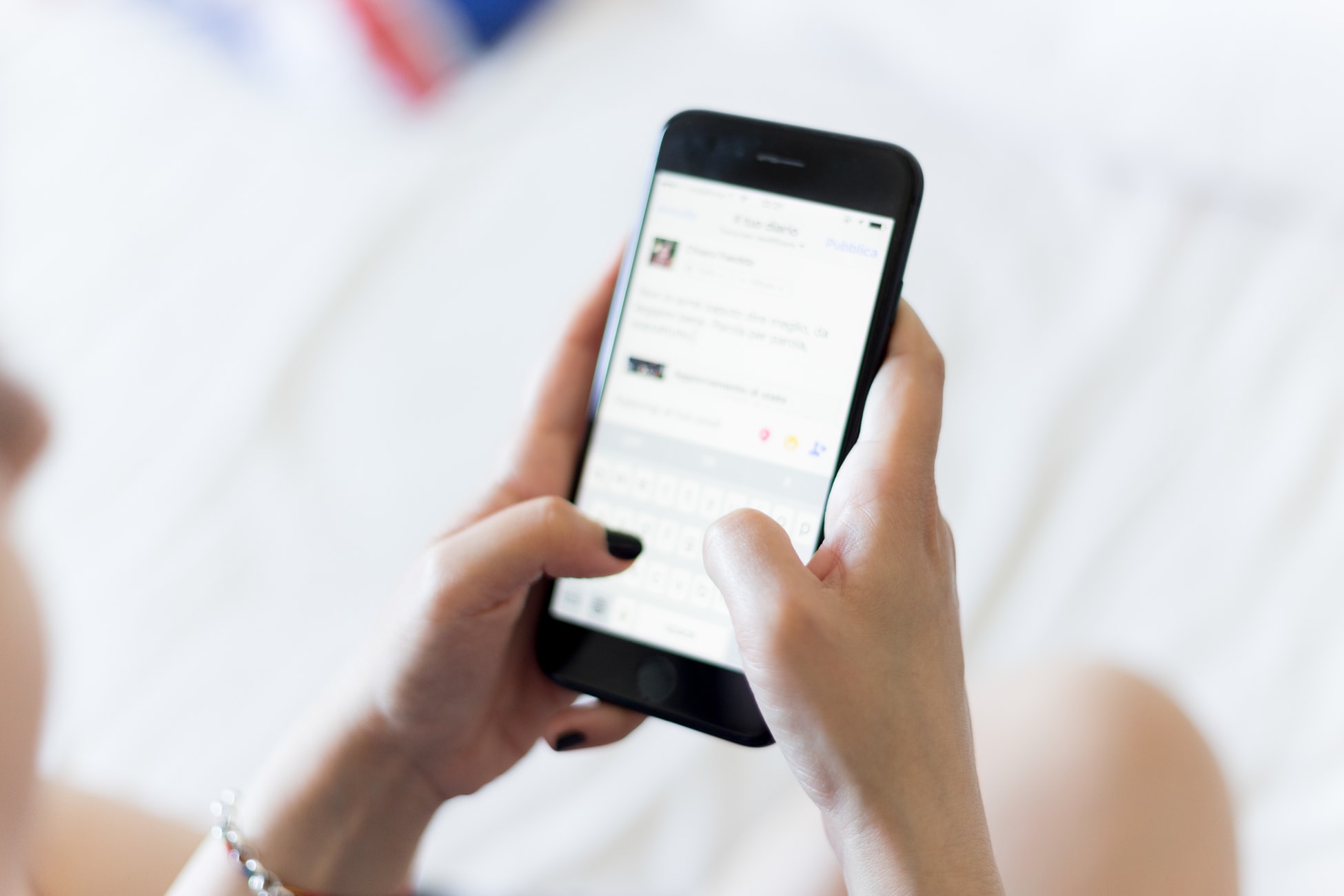 Woman writing a message on a smartphone