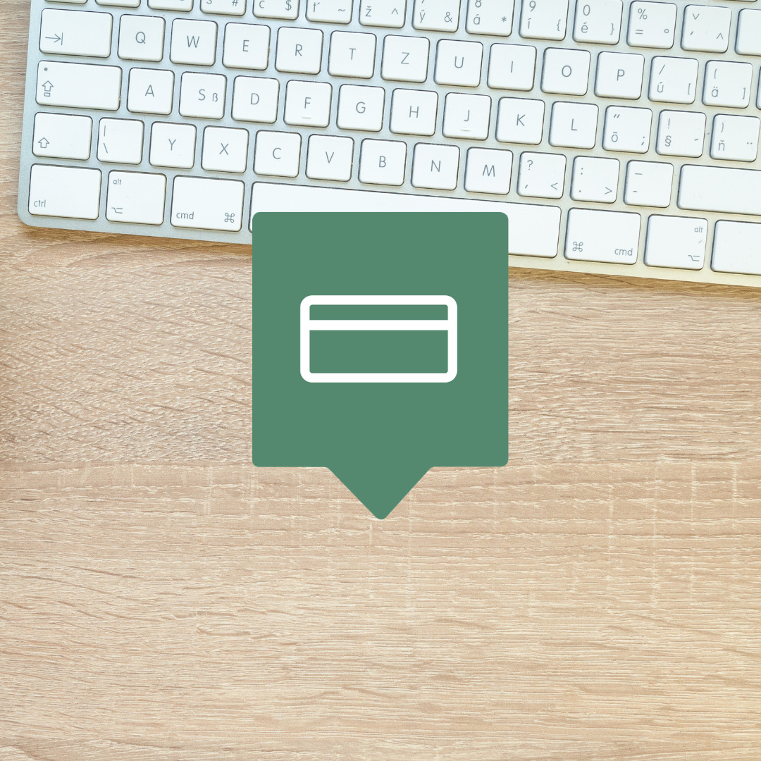 Et grønt ikon for nettbetaling foran en bordplate med et tastatur