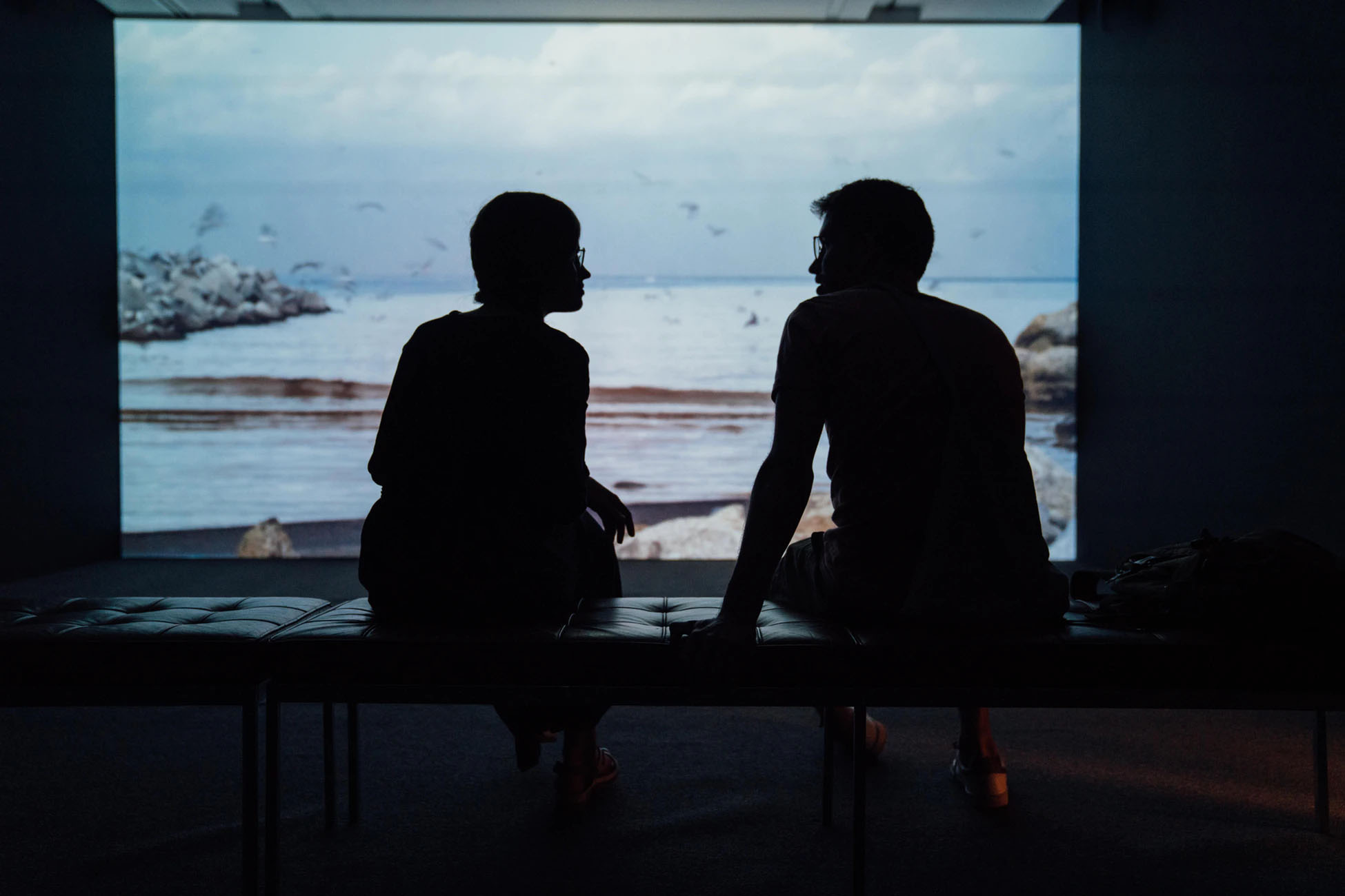 two people talking in front of a screen
