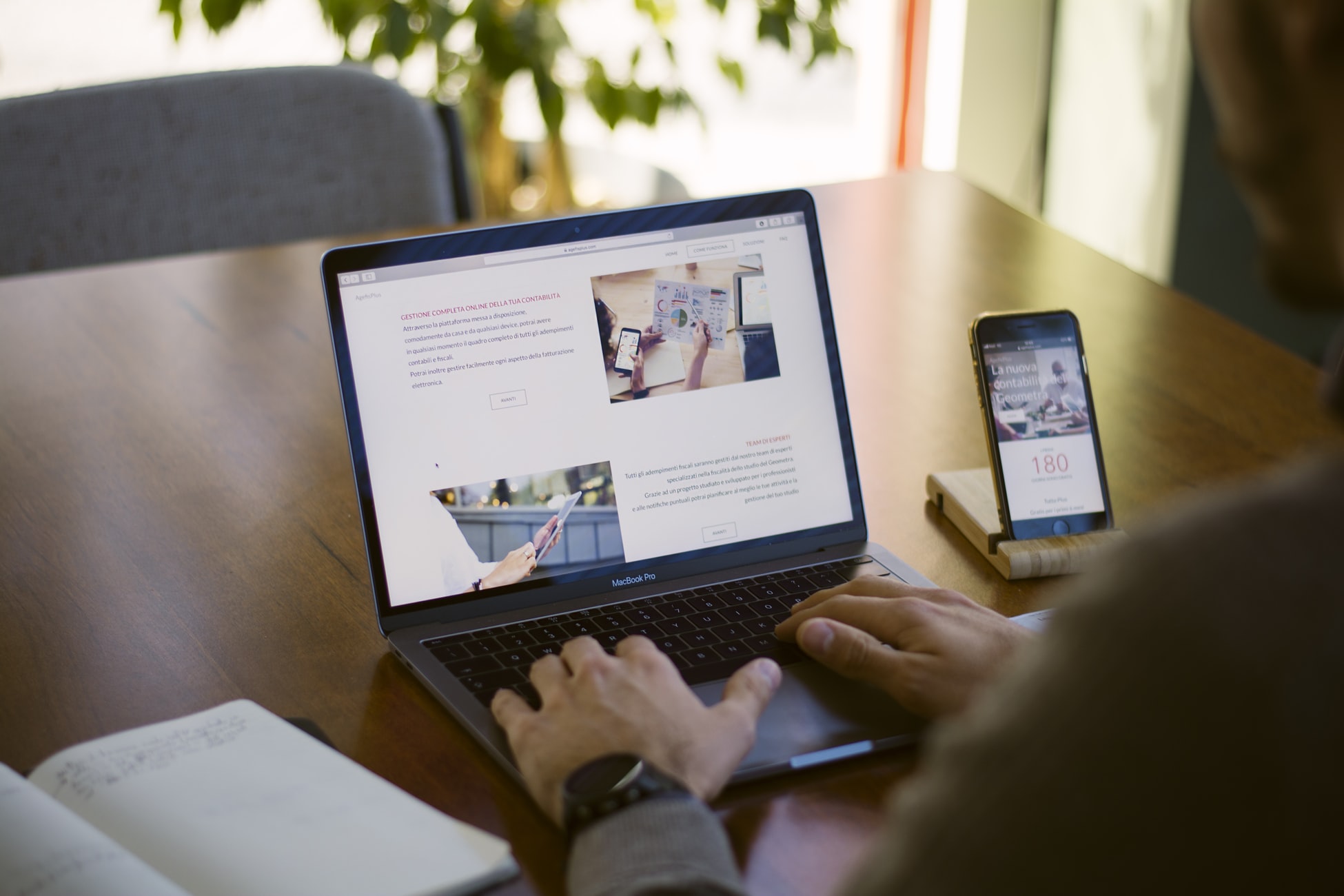 Man working at his workplace using a laptop, Notebook and a smartphone