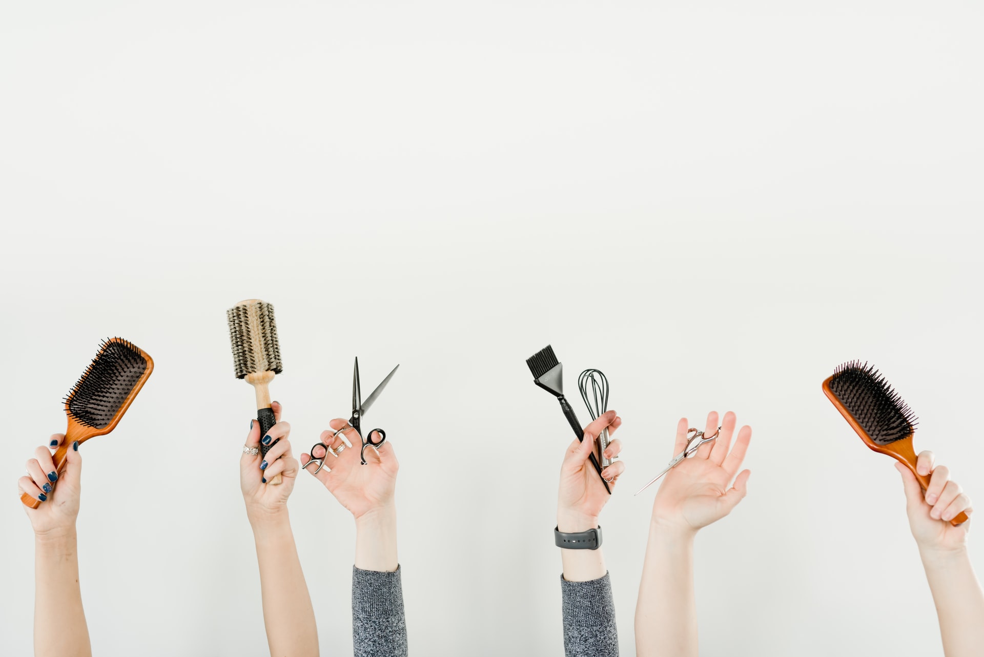 hands holding hairdresser supplies