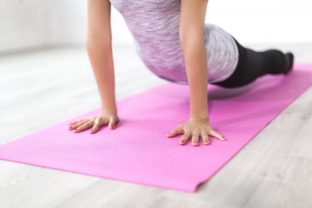 woman doing yoga on a mat