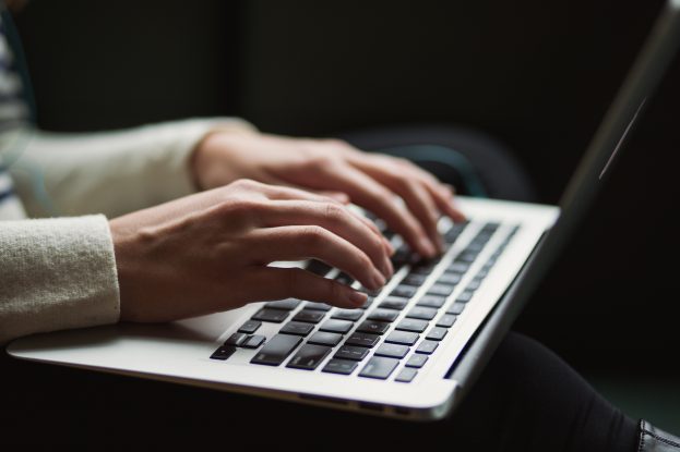 Woman typing on a laptop