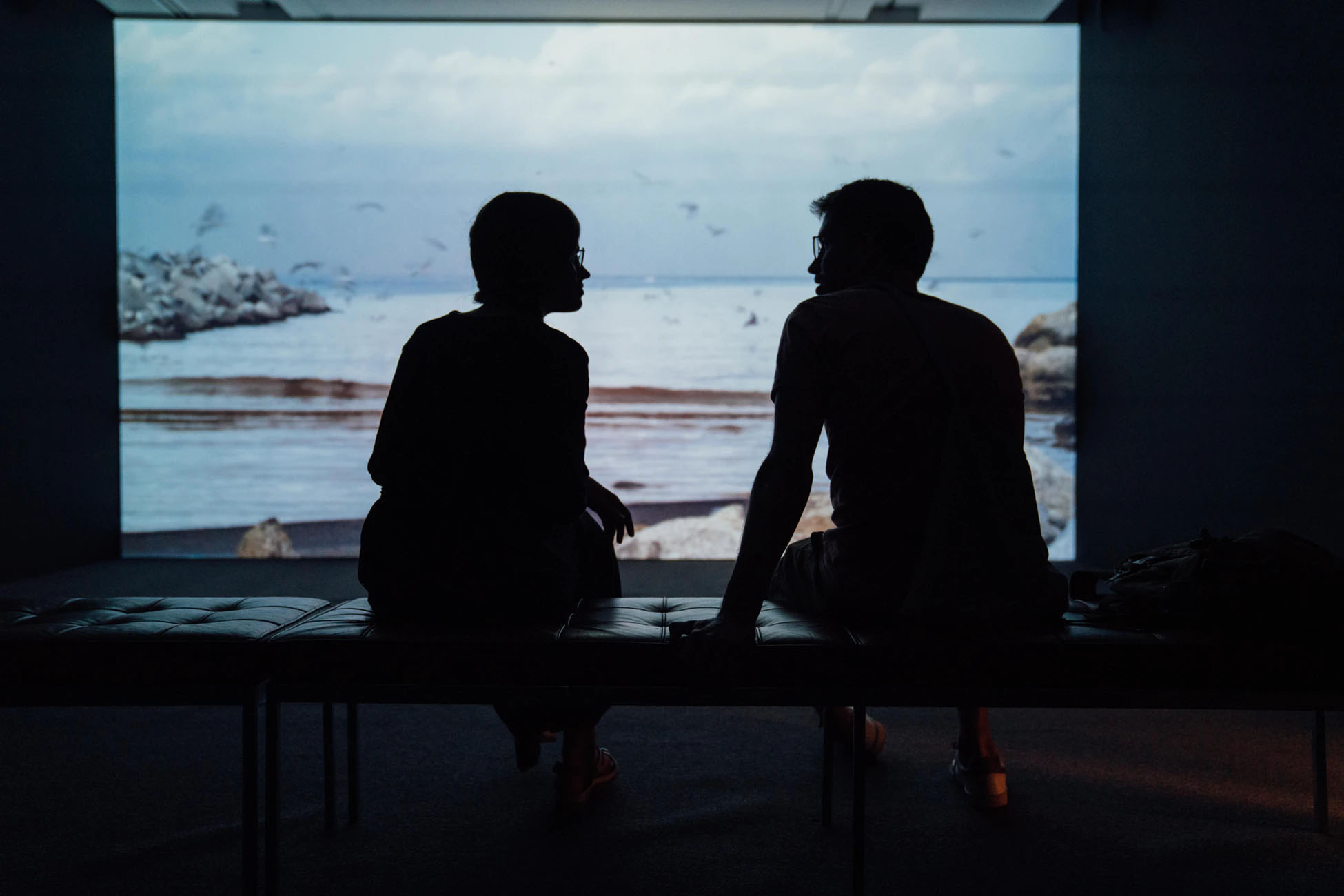 two people talking in front of the seaside