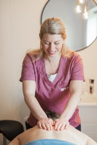 Muscle therapist and clinic owner Veronica Warhaug providing a treatment to a patient