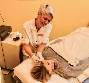 Clinic owner and therapist Hilde Sylstad providing treatment to a patient in her treatment room