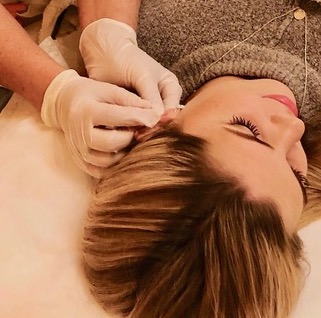 Clinic owner and therapist Hilde Sylstad providing treatment to a patient in her treatment room