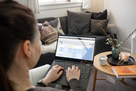Woman using a laptop showing her EasyPractice calendar