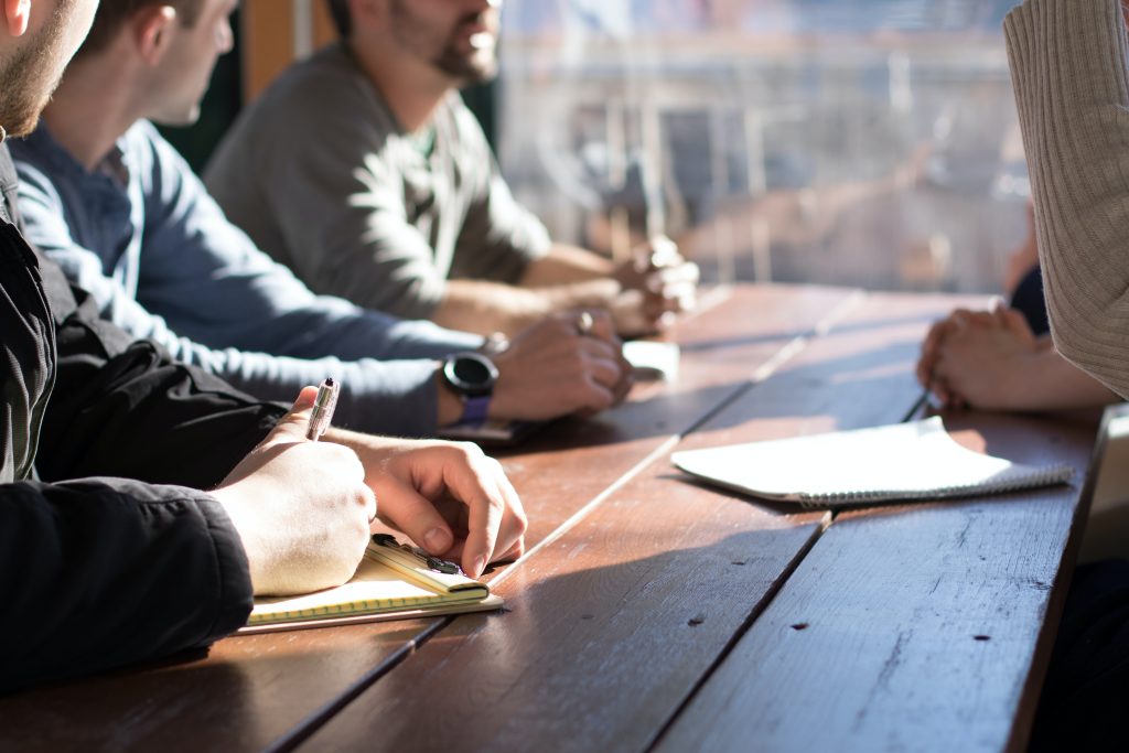 People sitting at a desk having a discussion