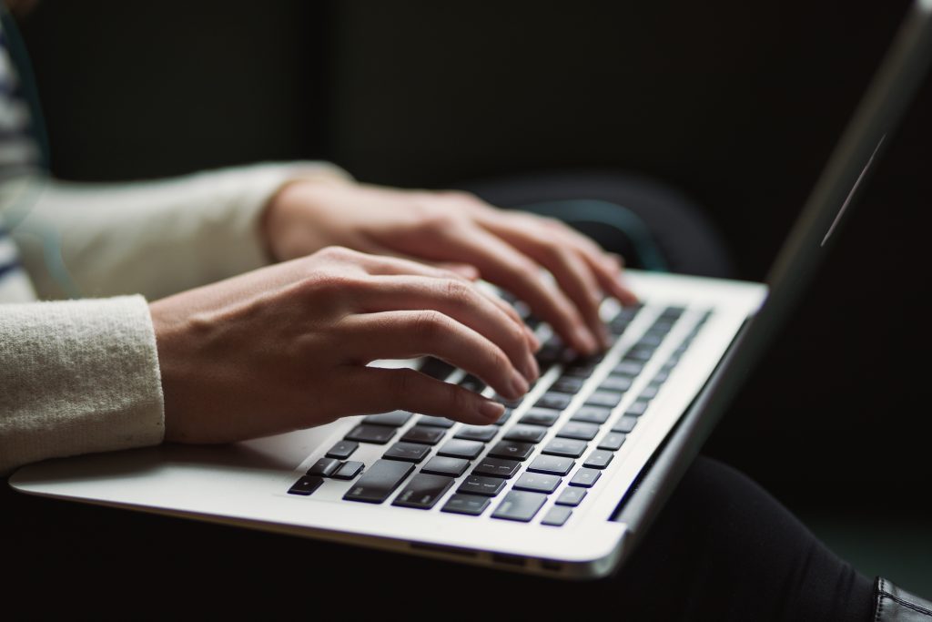 A person typing on her laptop.