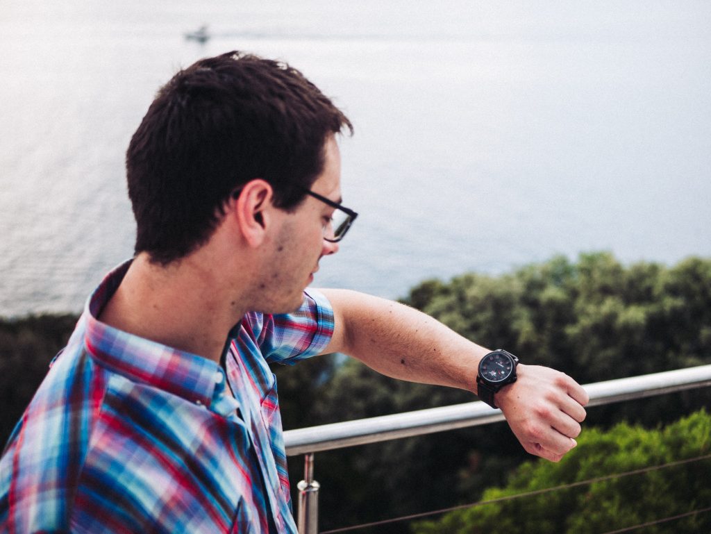 A man takes a look at his wrist watch