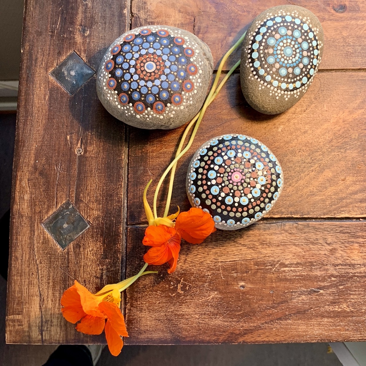 Painted stones on a wooden table