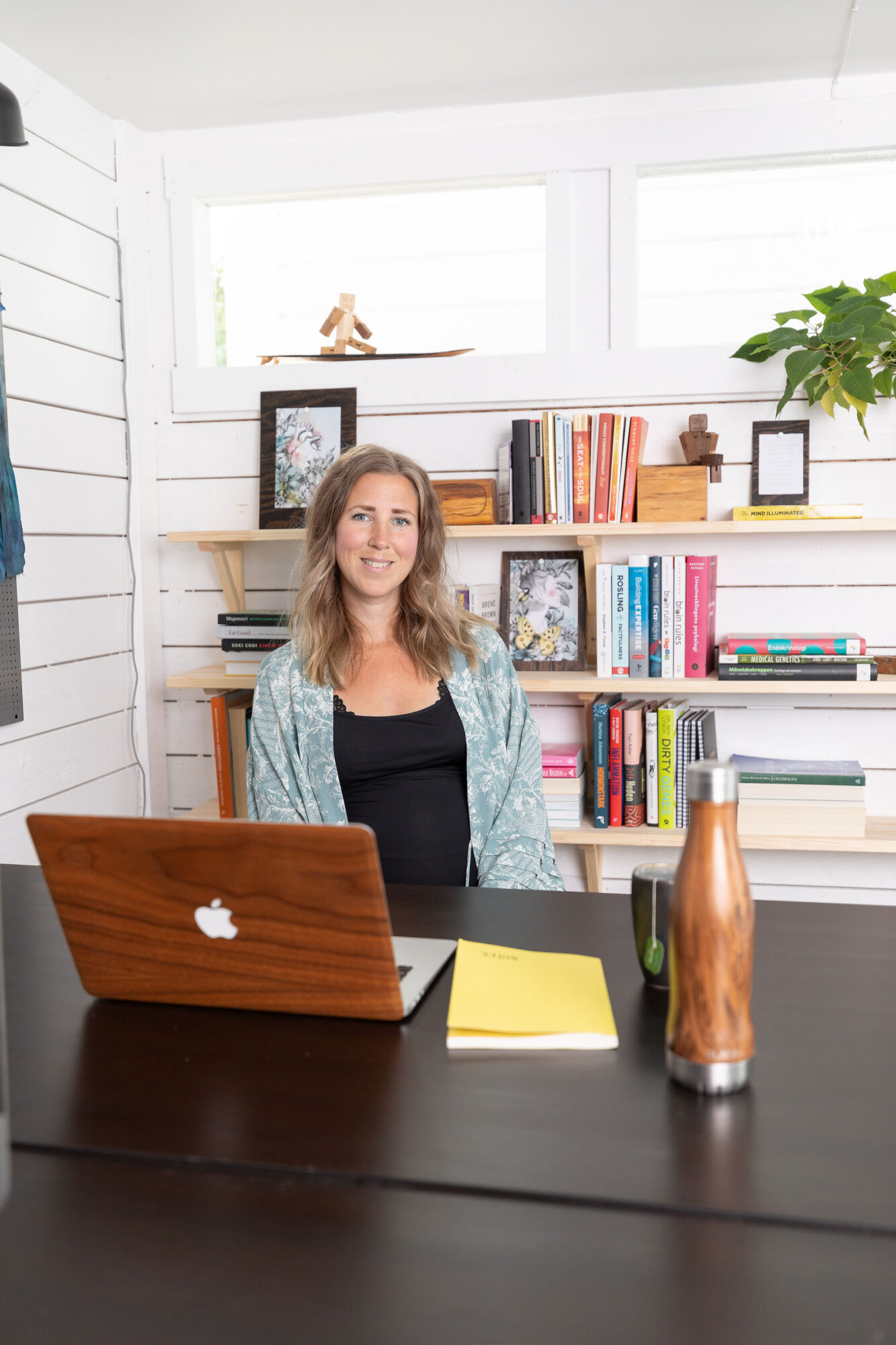 Maria Särén sitting in front of her work desk in her office