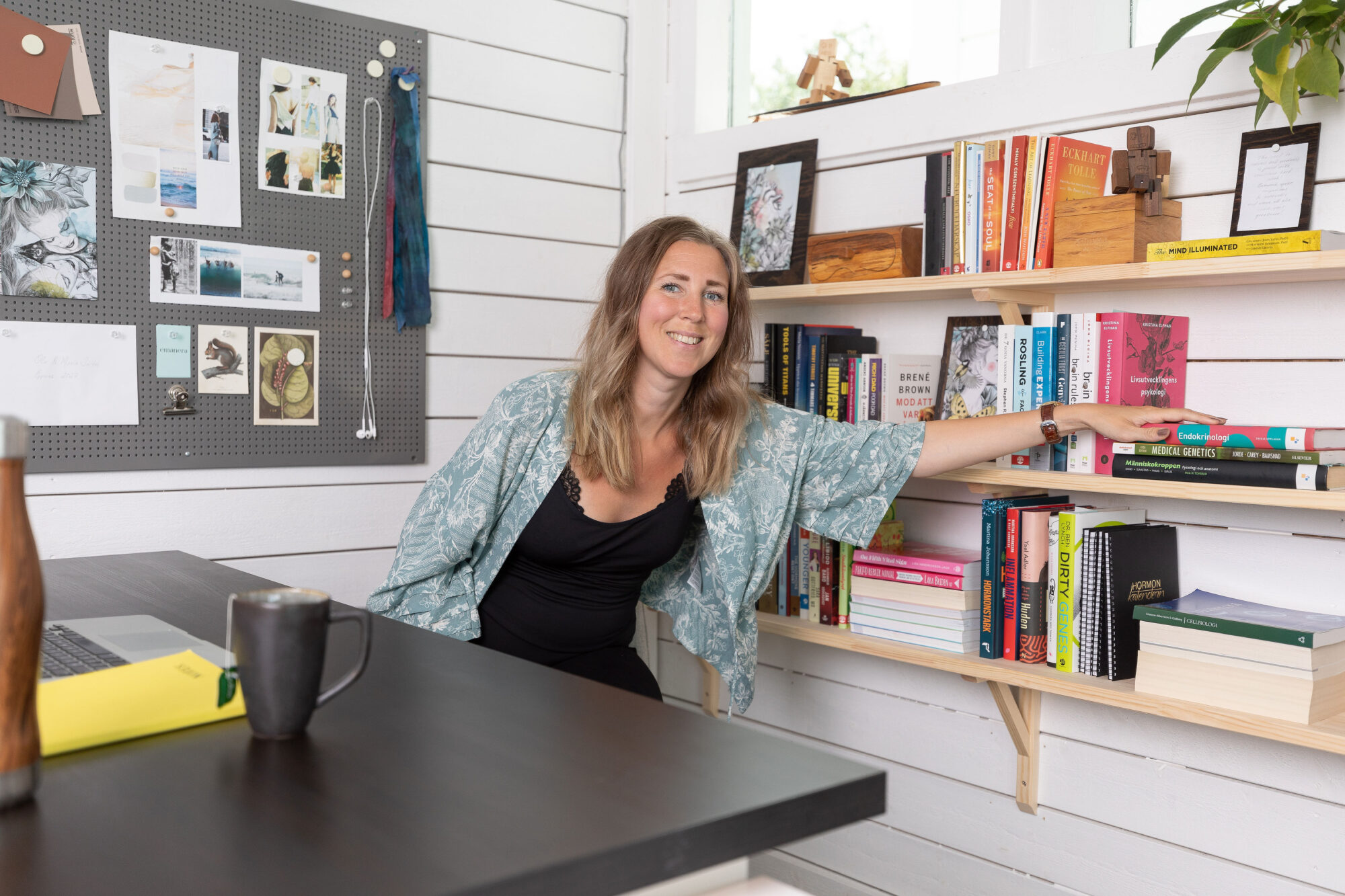 Maria Särén sitting in front of her work desk in her office