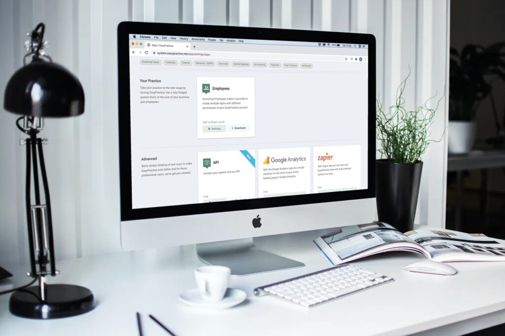 Modern desk with a desktop displaying the EasyPractice homepage