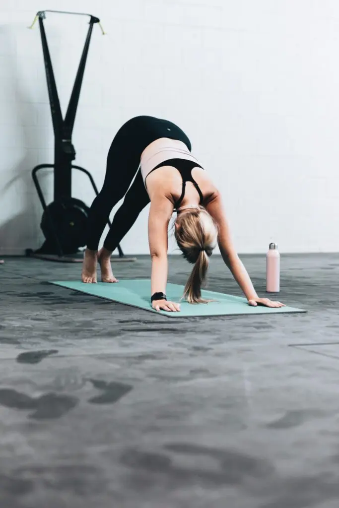 A woman in an exercise room working out.