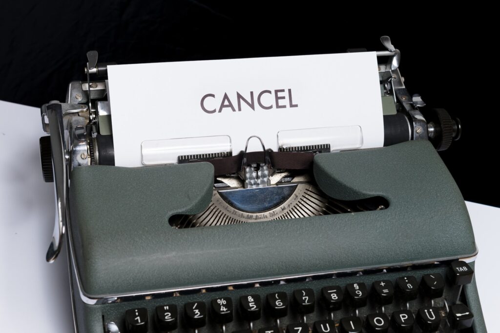 typewriter with a paper saying "CANCEL"