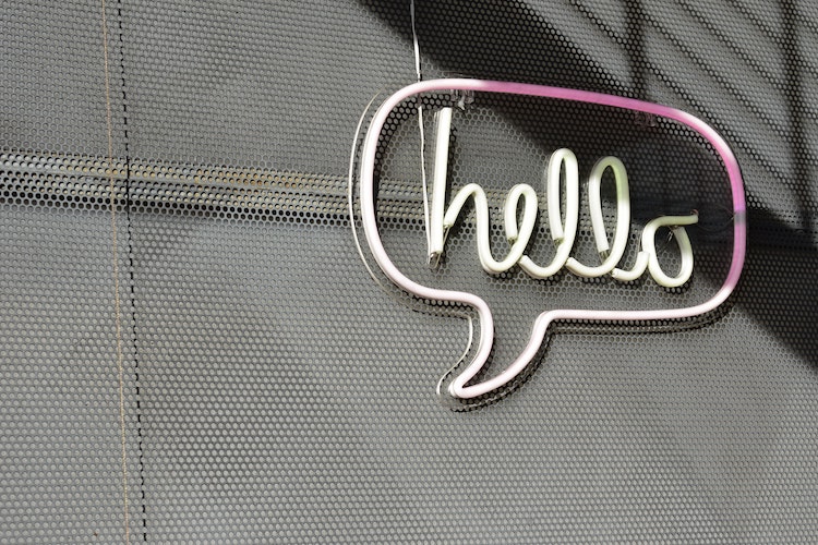 Image of a neon speech bubble saying "hello"