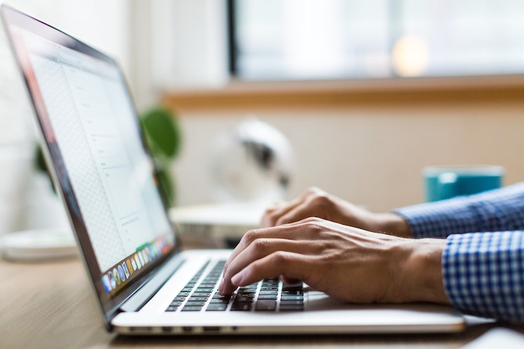 Man typing on a laptop