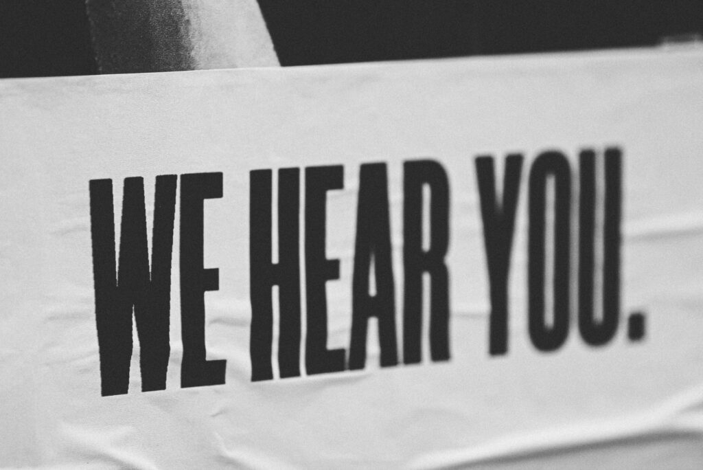 Poster saying "WE HEAR YOU"