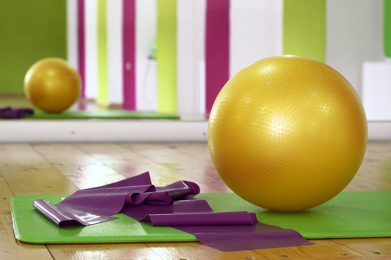 Pilates ball, yoga mat and exercise rubber band