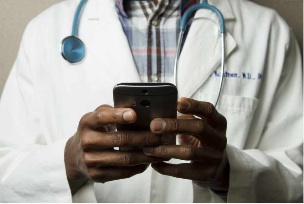 Doctor holding a smartphone.