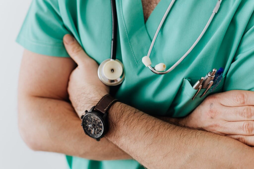 doctor in scrubs with hands crossed