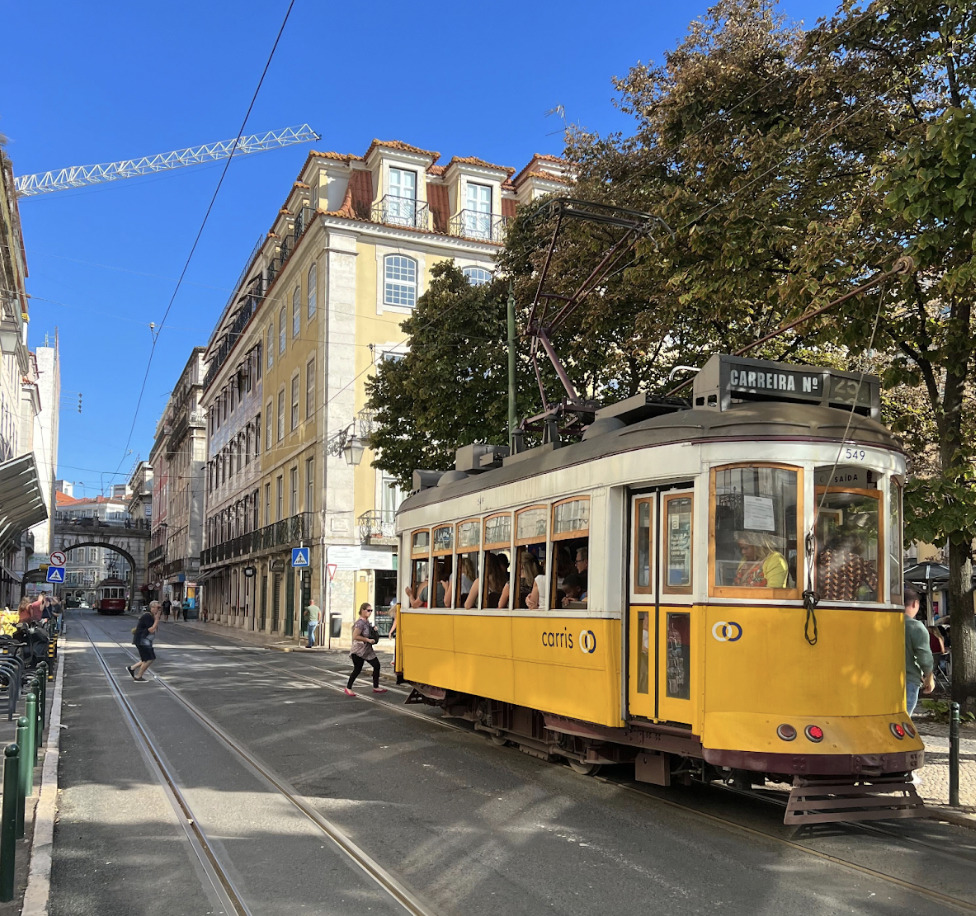 A yellow tram in the streets of Lisbon