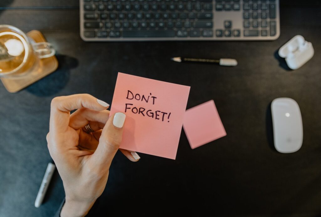 A pink post-it note with a reminder on
